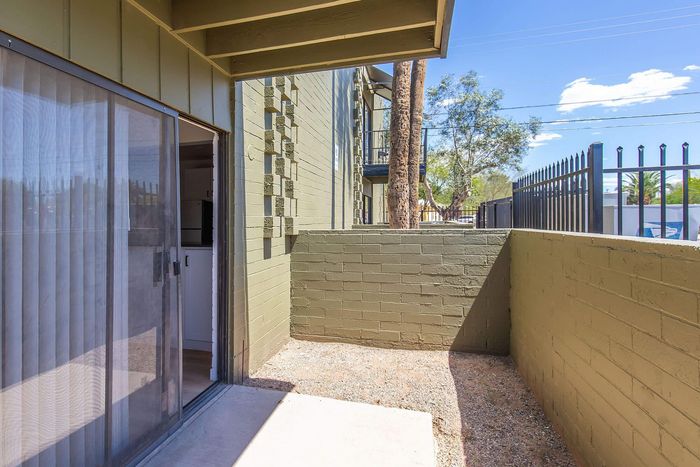 Charming outdoor patio space with sliding glass door, perfect for relaxation and enjoying fresh air.