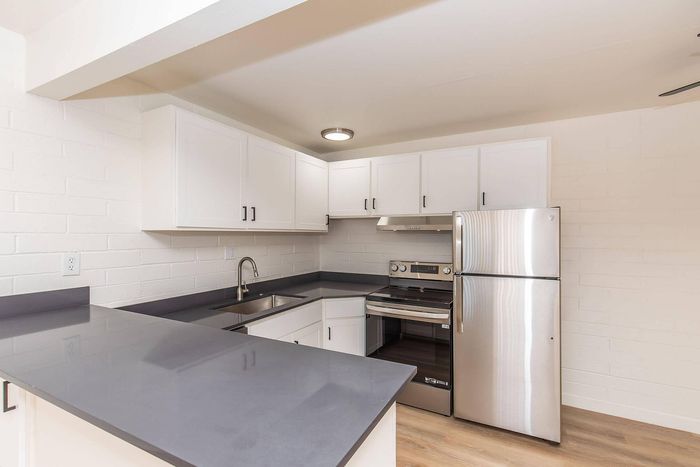 Modern kitchen with sleek countertops, stainless steel appliances, and ample white cabinetry.