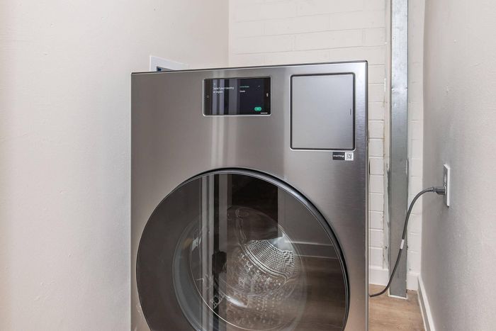 Modern stainless steel washing machine in a sleek laundry nook, offering efficient and stylish convenience.