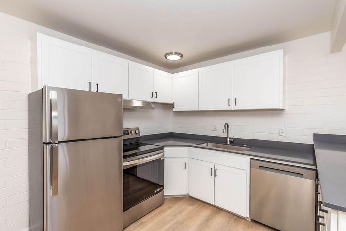 Modern kitchen with sleek stainless steel appliances, elegant white cabinetry, and a contemporary design.