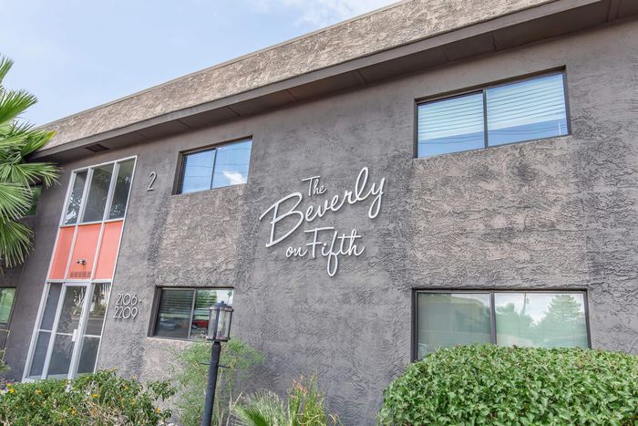 Charming apartment exterior of The Beverly on Fifth with modern architecture and lush greenery.
