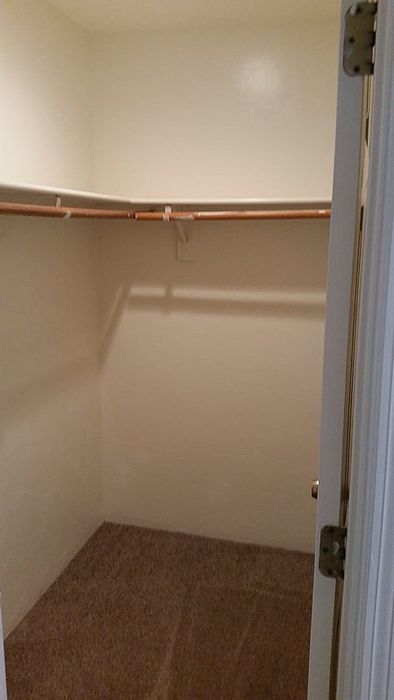 Spacious walk-in closet with ample shelving and storage space, perfect for organizing your wardrobe.