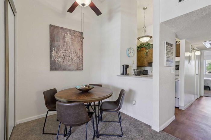 Charming dining nook with modern decor and cozy seating next to open kitchen, perfect for intimate gatherings and daily meals.