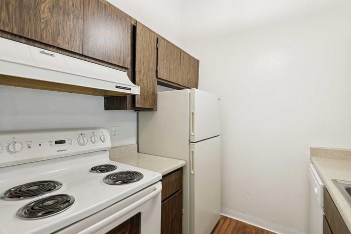 Charming kitchen featuring vintage-style appliances, wooden cabinets, and sleek countertops.