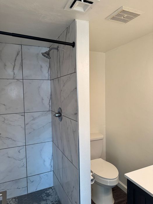 Modern bathroom featuring elegant marble tile shower and sleek fixtures for a luxurious touch.