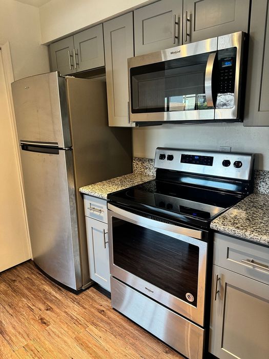 Modern kitchen featuring sleek stainless steel appliances, elegant granite countertops, and contemporary cabinetry, creating a stylish and functional cooking space.