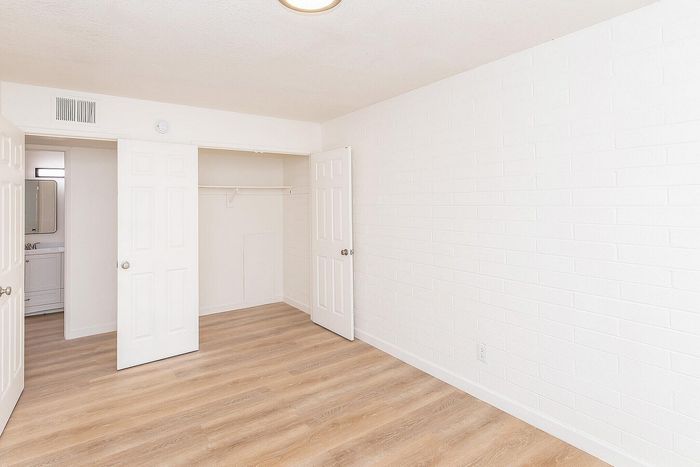 Bedroom with hardwood floors, closet and en-suite bathroom at Miramonte on 3rd in Tucson, AZ