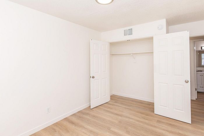Bedroom with hardwood floors, closet and en-suite bathroom at Miramonte on 3rd in Tucson, AZ