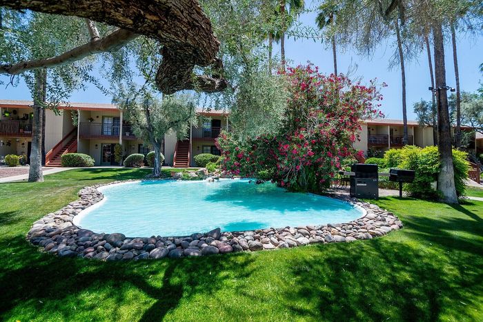 Charming garden view with a serene swimming pool, lush greenery, and vibrant flowers, perfect for relaxation and enjoyment.