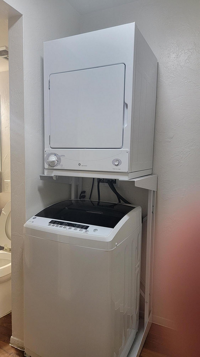 Efficient and compact in-unit laundry with modern stacked washer and dryer, ideal for convenient living.