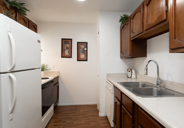 Charming kitchen with elegant wood cabinets, spacious countertops, and modern appliances, perfect for culinary enthusiasts.