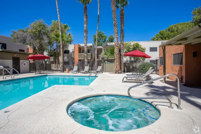 Beautiful apartment courtyard with lush green lawn, mature trees, picnic area, and charming pathway.Beautiful apartment courtyard with lush green lawn, mature trees, picnic area, and charming pathway.