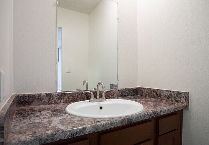 Modern bathroom with elegant marble countertop and sleek fixtures, offering a serene, stylish feel.