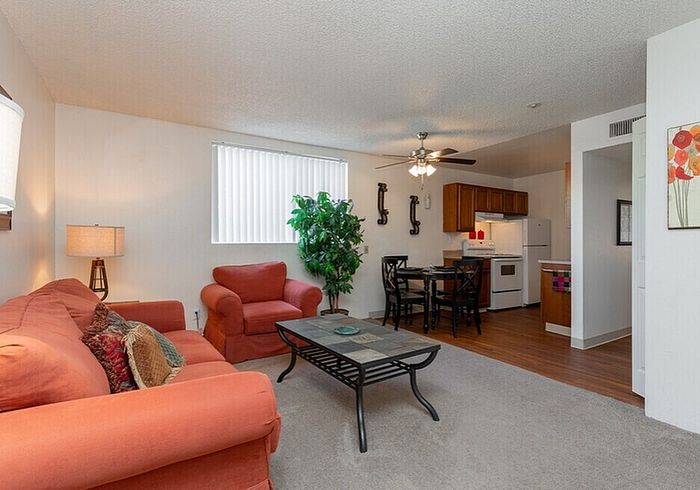 Inviting living space with cozy seating, modern decor, and open kitchen ideal for social gatherings.