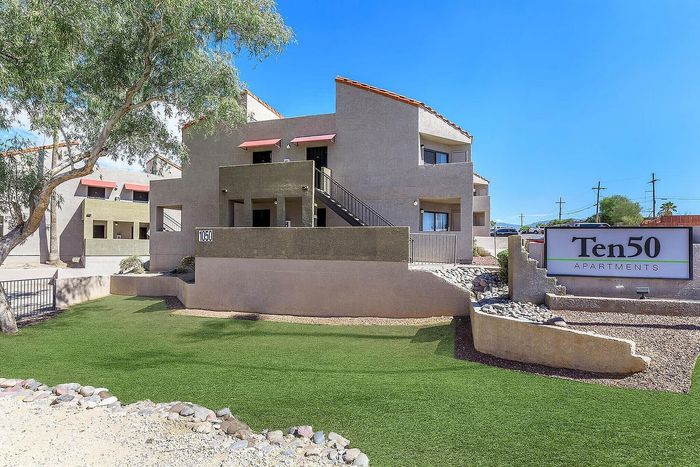 Inviting exterior view of Ten50 Apartments showcasing modern architecture with pristine landscaping and a welcoming entry.
