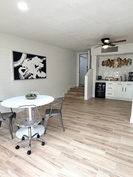 Bright open-plan living space featuring modern dining area with chic furniture and stylish kitchen design.