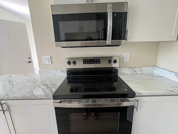 Modern kitchen featuring sleek stainless steel appliances and elegant marble countertops.