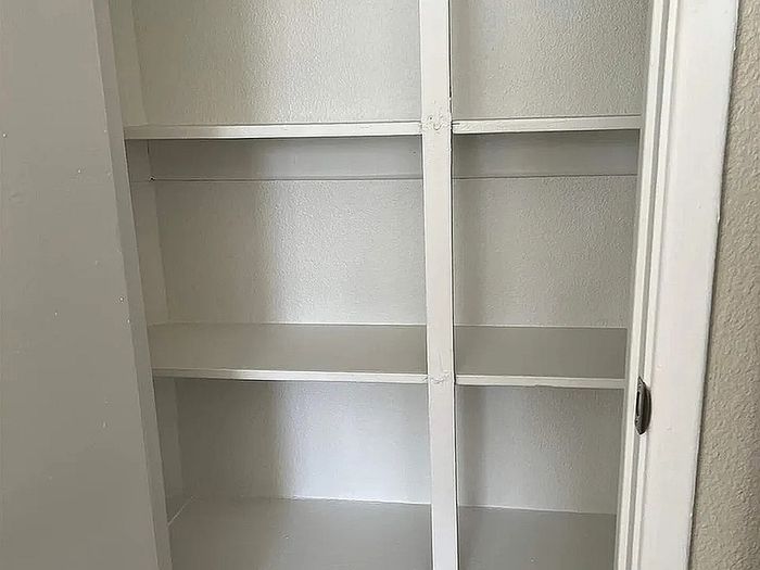 Spacious built-in storage shelves in a modern apartment, ideal for efficient organization and style.
