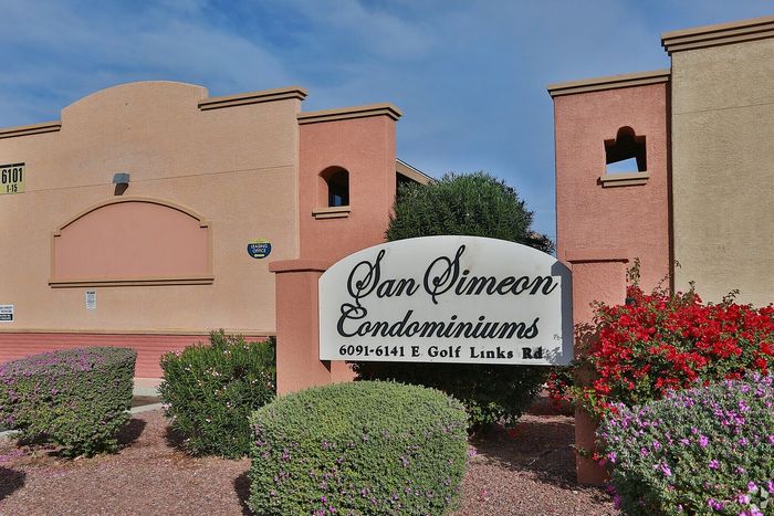 Inviting entrance to San Simeon Condominiums with vibrant landscaping and a welcoming atmosphere on E. Golf Links Rd.