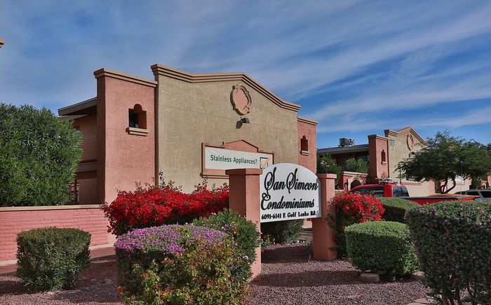 Charming San Simeon Condominiums with vibrant landscaping and elegant architecture.