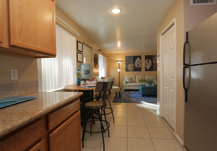 Inviting open-plan kitchen and living area with cozy seating, modern appliances, and warm lighting.