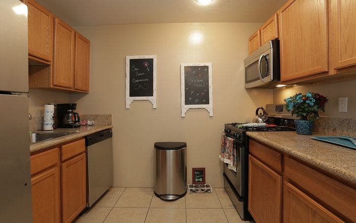 Charming modern kitchen with stainless steel appliances, oak cabinets, and elegant granite countertops.