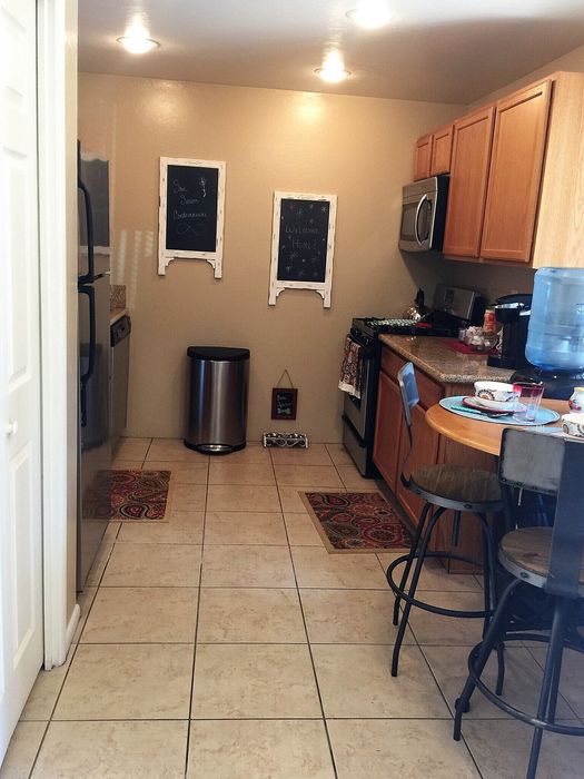 Cozy kitchen featuring wooden cabinets, modern appliances, and a charming dining nook with warm lighting.