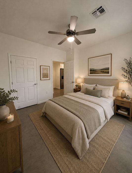 Cozy bedroom with elegant decor, inviting queen-sized bed, modern ceiling fan, and ambient lighting.