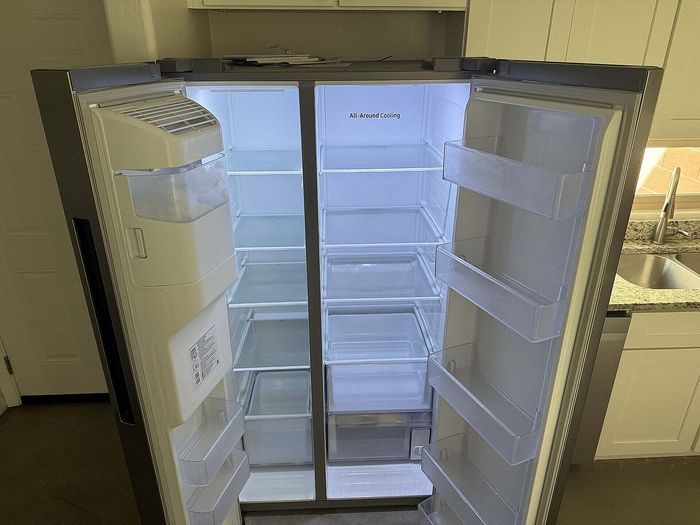 Spacious dual-door refrigerator with all-around cooling in a modern kitchen setting, offering ample storage with sleek shelving.