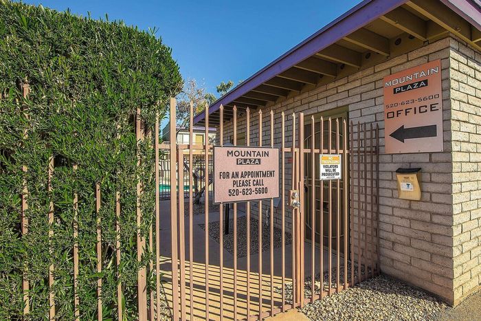 Charming entrance to Mountain Plaza, showcasing inviting office signage and lush greenery for an inviting first impression.
