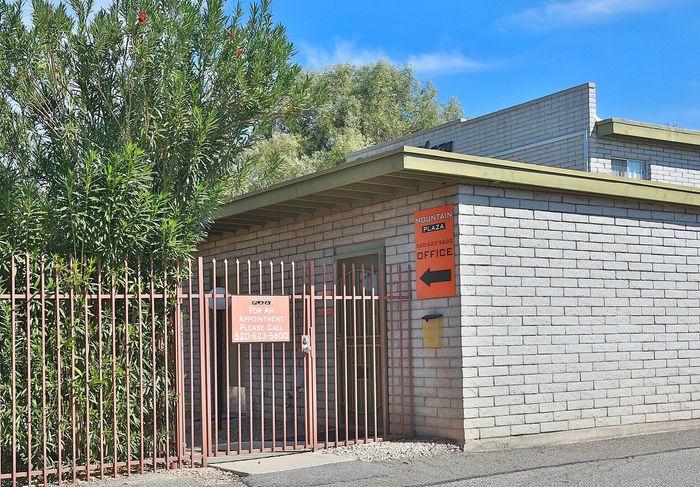 Charming gated entrance to Mountain Plaza, surrounded by lush greenery and highlighting the office for easy navigation.
