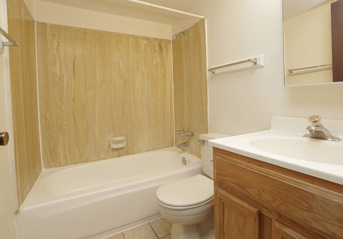 Elegant bathroom with a modern tub, sleek fixtures, and stylish wood accents, perfect for a relaxing retreat.