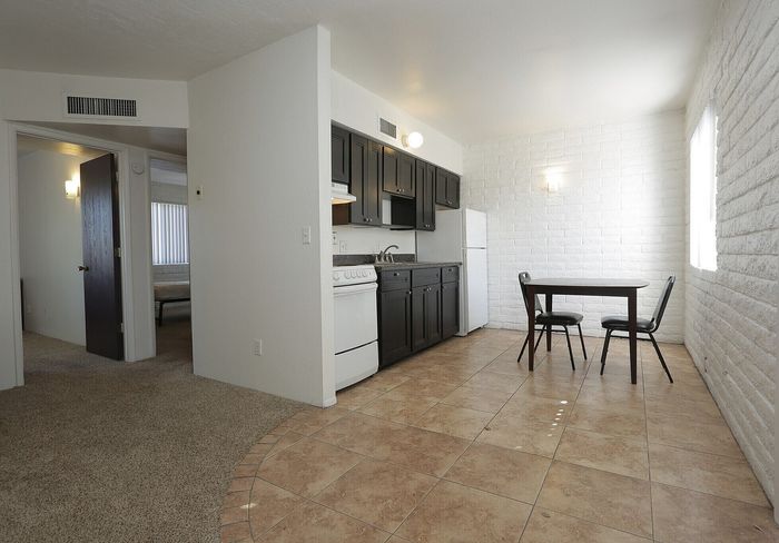 Charming apartment kitchen with modern cabinetry, a cozy dining space, and inviting natural light.