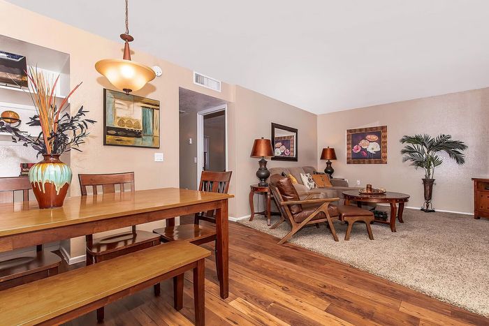Warm and inviting open-concept living room with elegant wooden furniture, cozy seating, and stylish decor accents.