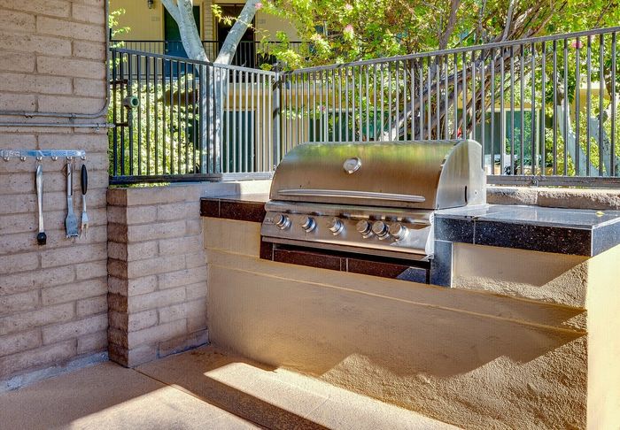Inviting outdoor grill area with a sleek stainless steel barbecue, perfect for hosting gatherings and enjoying al fresco dining.