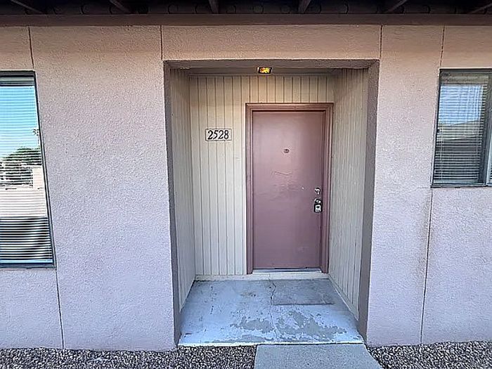Welcoming entrance of charming apartment with a modern exterior and stylish design at door number 2528.