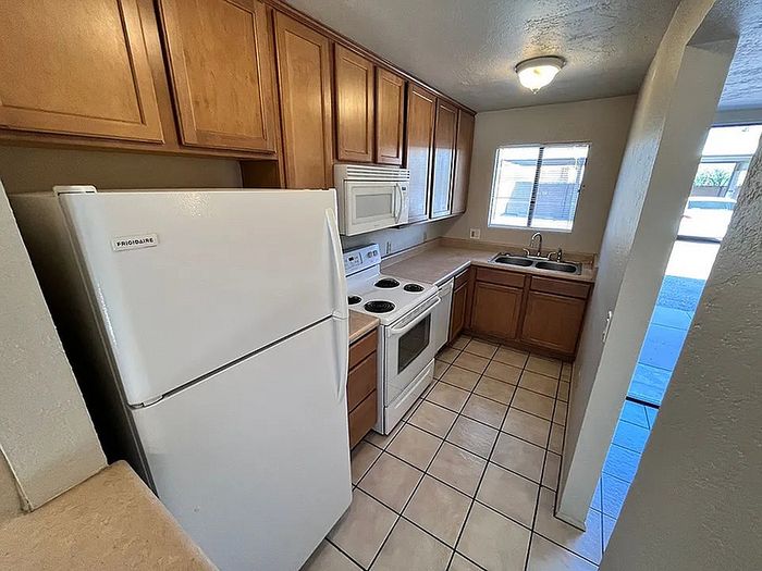 Charming kitchen with sleek wooden cabinetry, modern appliances, and ample natural light.