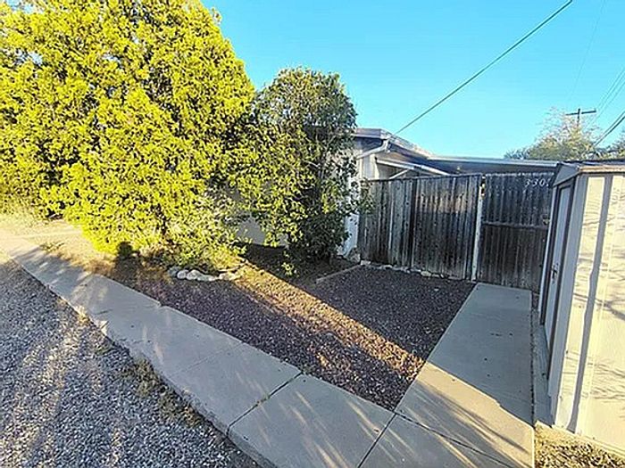 Inviting outdoor space with charming trees and a private entrance, perfect for relaxation in a serene setting.
