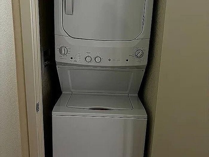 Compact laundry area featuring a modern stackable washer and dryer unit, offering convenience and efficiency.