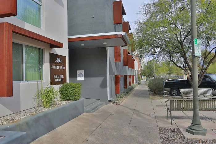 Chic apartment entrance showcasing modern architecture with rental availability at Julian Drew Block Flats.