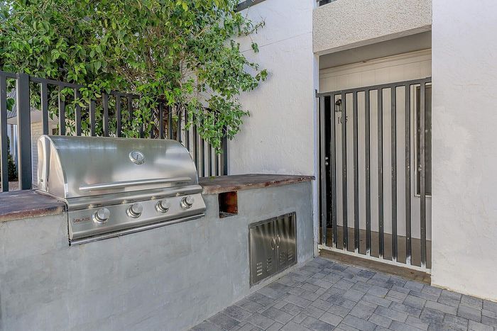 Inviting outdoor space featuring a sleek stainless steel grill, perfect for entertaining and barbecues.