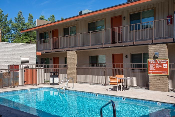 Inviting apartment complex with a sparkling outdoor pool and modern amenities, ideal for relaxation and leisure.
