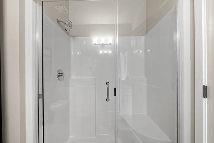 Elegant modern bathroom with a sleek glass-enclosed shower and contemporary fixtures.