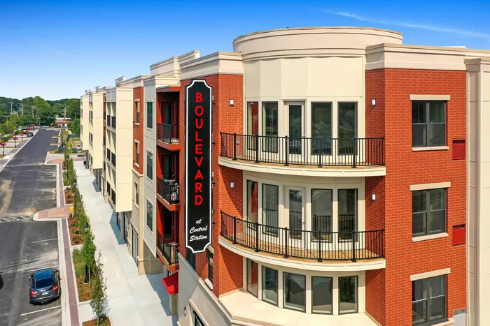 Modern apartment complex featuring elegant balconies and stylish brick facade at Boulevard Central Station.