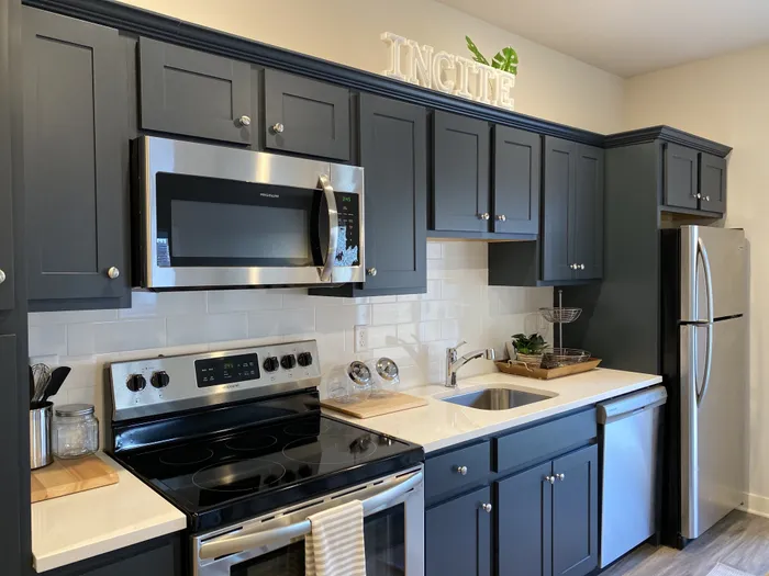 Black Cabinetry & Stainless Steel Appliances in Kitchen at Incite at Troy | Student Apartments in Troy, NY
