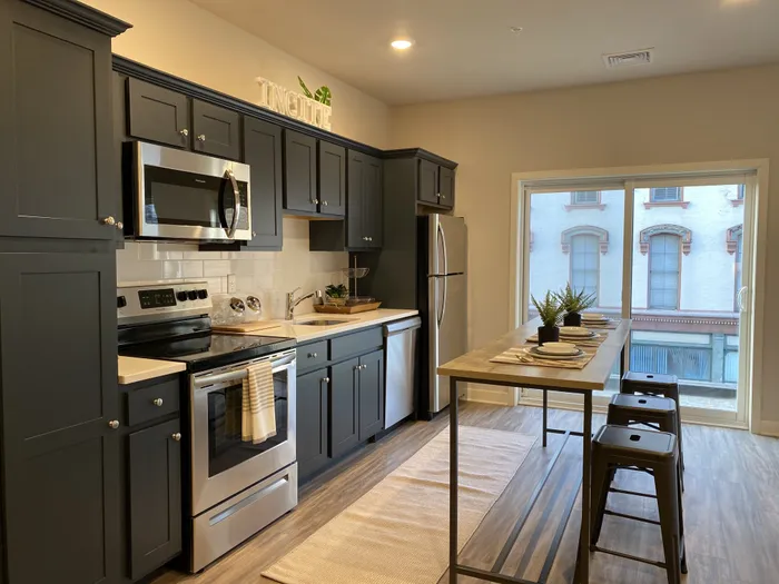 Black Cabinetry & Stainless Steel Appliances in kitchen at Incite at Troy | Apartments near RPI