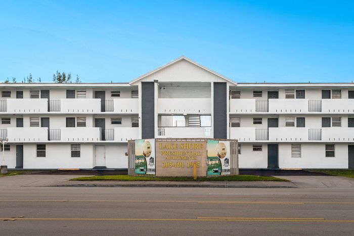 Elegant three-story apartment building with modern design and spacious balconies at Lake Shore Presidential Apartments.