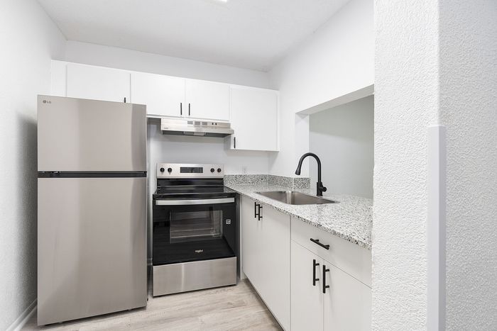 Modern kitchen design with sleek stainless steel appliances and elegant granite countertops.