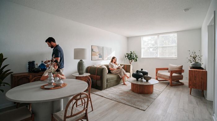 Elegant living room with modern decor, featuring a cozy sofa, stylish wooden furniture, and bright natural lighting.