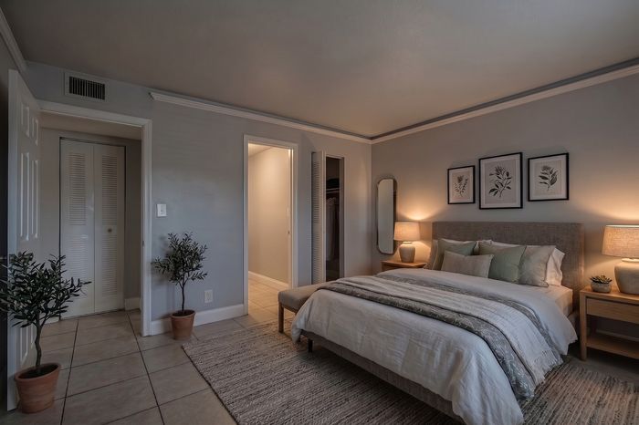 Elegant bedroom with a cozy king-sized bed, soft lighting, and stylish decor, exuding comfort and relaxation.